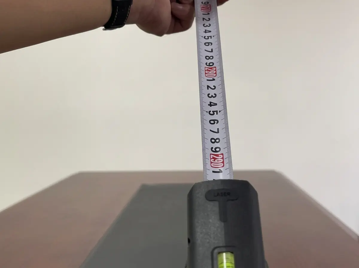 Mountlaser LTM01 laser tape measure with visible spirit-level indicator during alignment